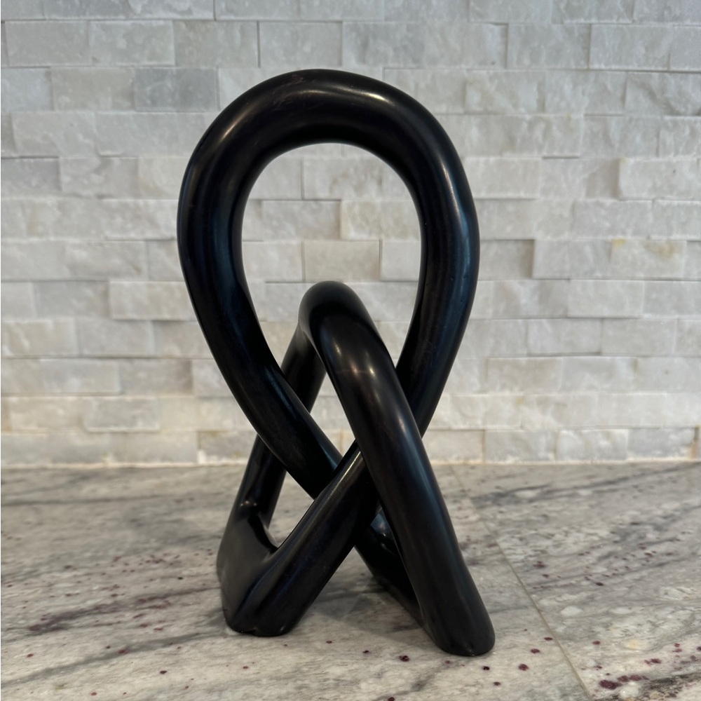 Black eternal love knot sculpture